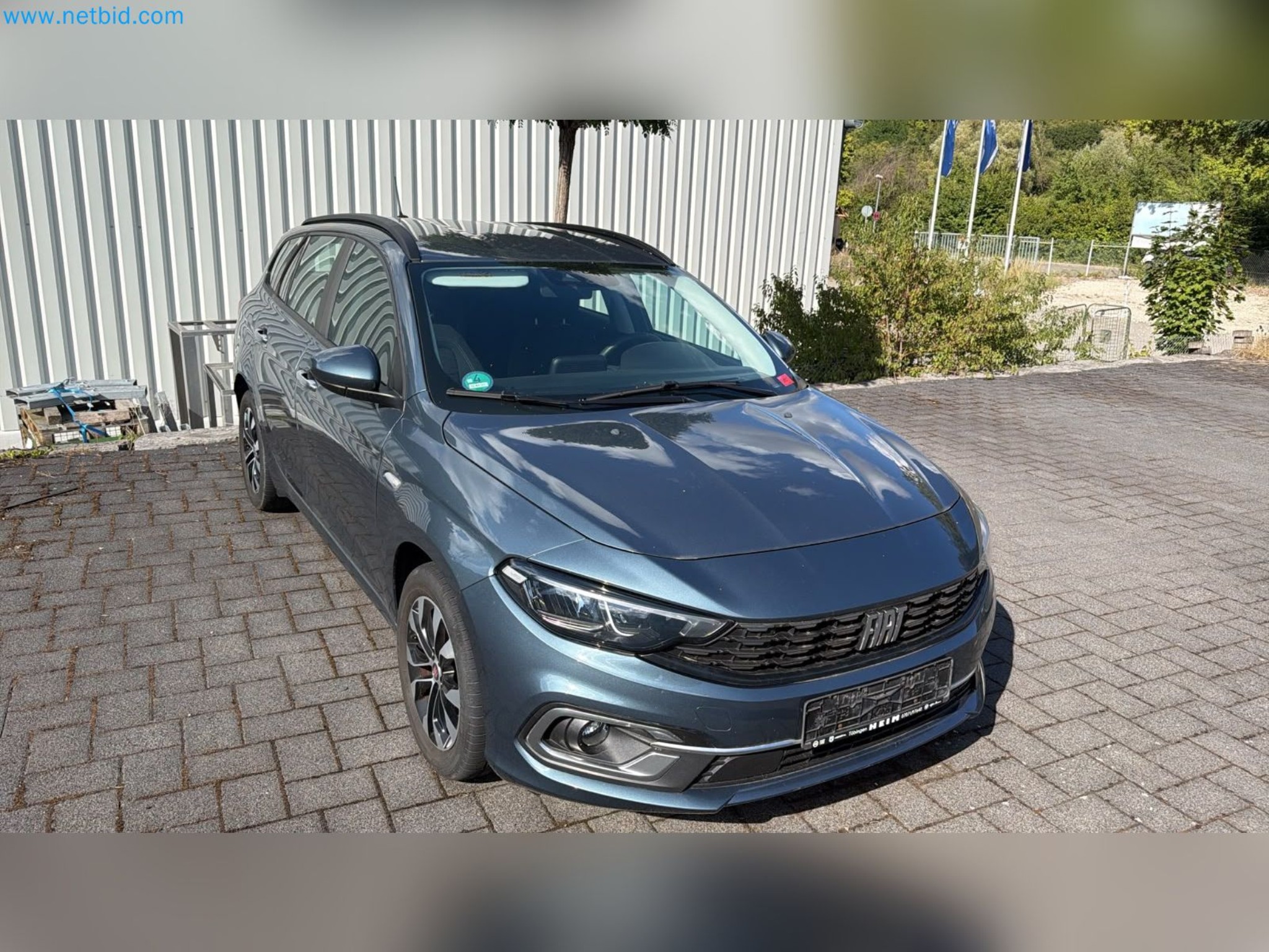 Passenger cars, electric cars, and automotive repair shop equipment at a Fiat dealership-1