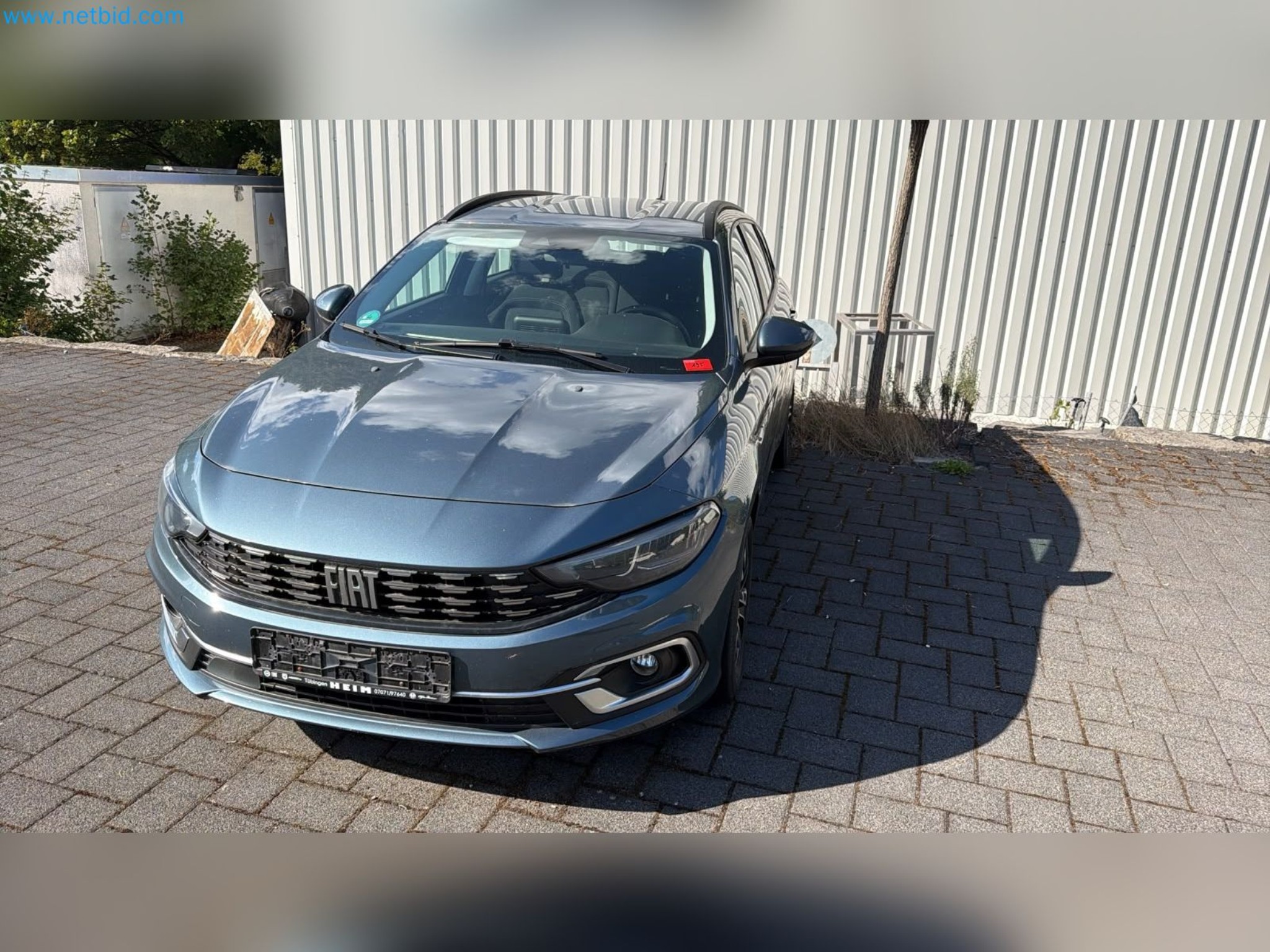 Passenger cars, electric cars, and automotive repair shop equipment at a Fiat dealership-2