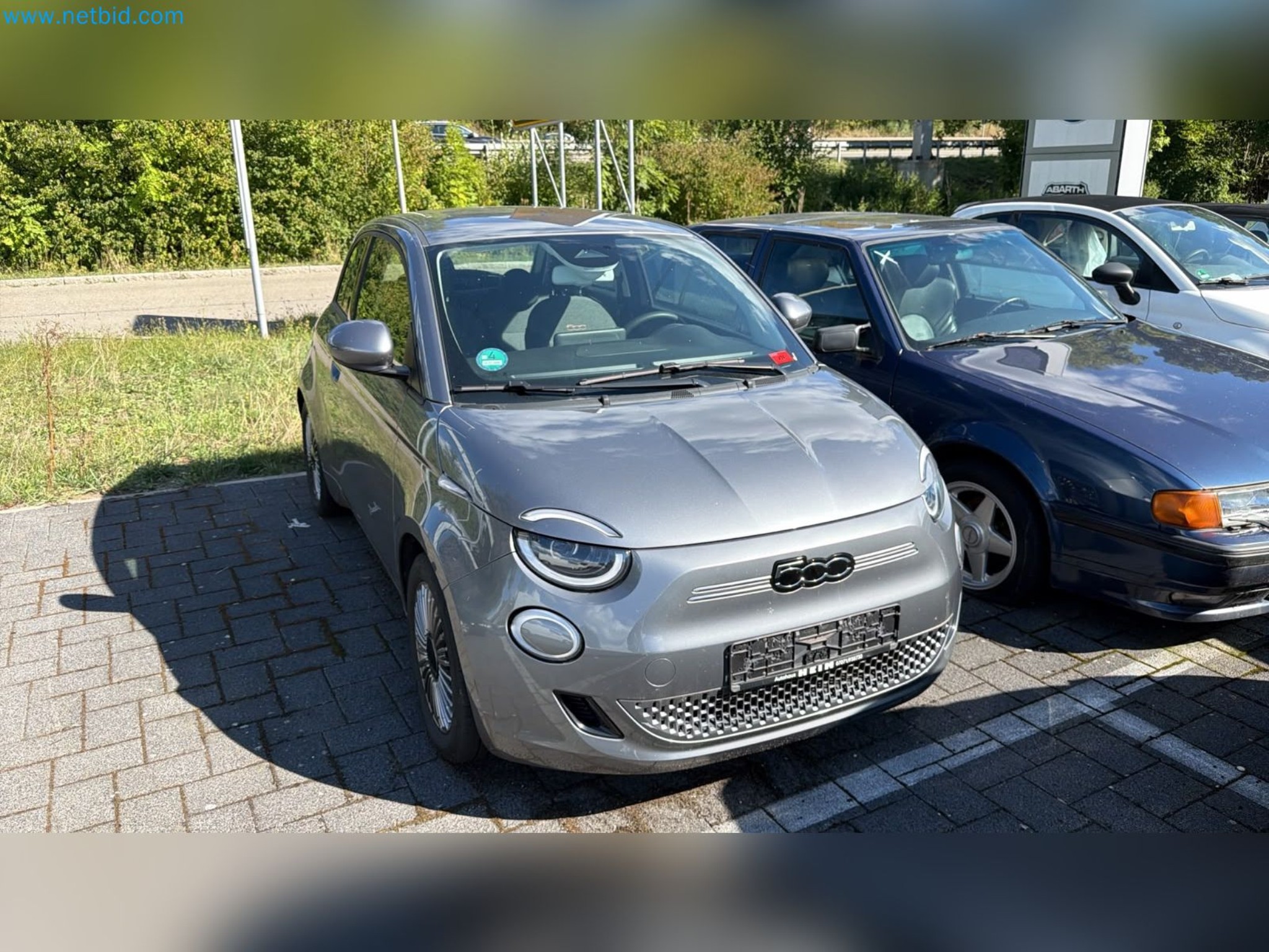 Passenger cars, electric cars, and automotive repair shop equipment at a Fiat dealership-1