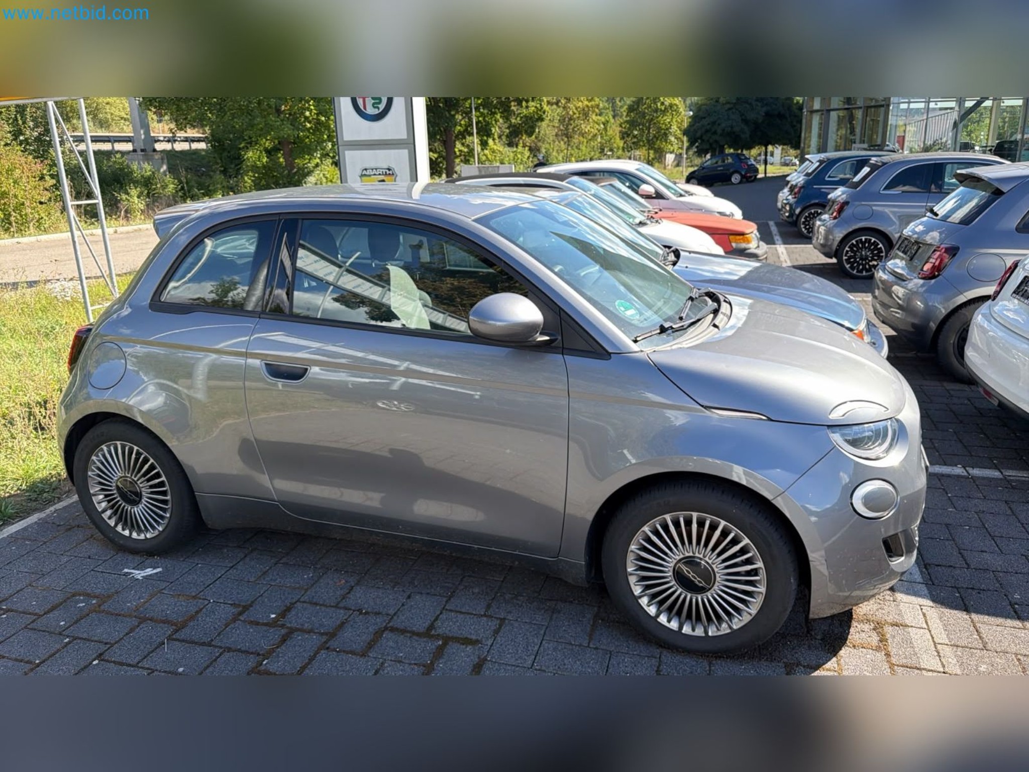 Passenger cars, electric cars, and automotive repair shop equipment at a Fiat dealership-2