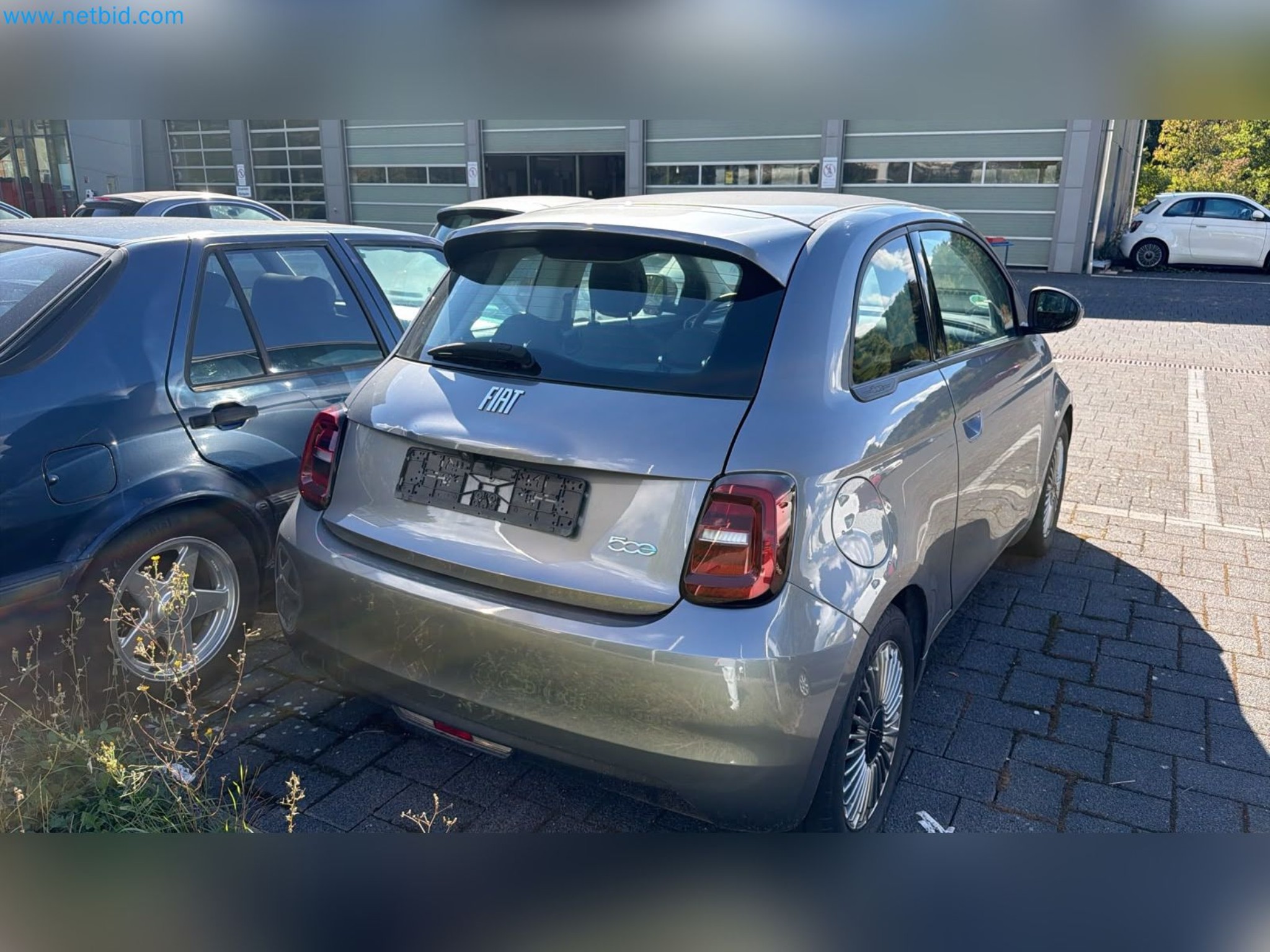 Passenger cars, electric cars, and automotive repair shop equipment at a Fiat dealership-3