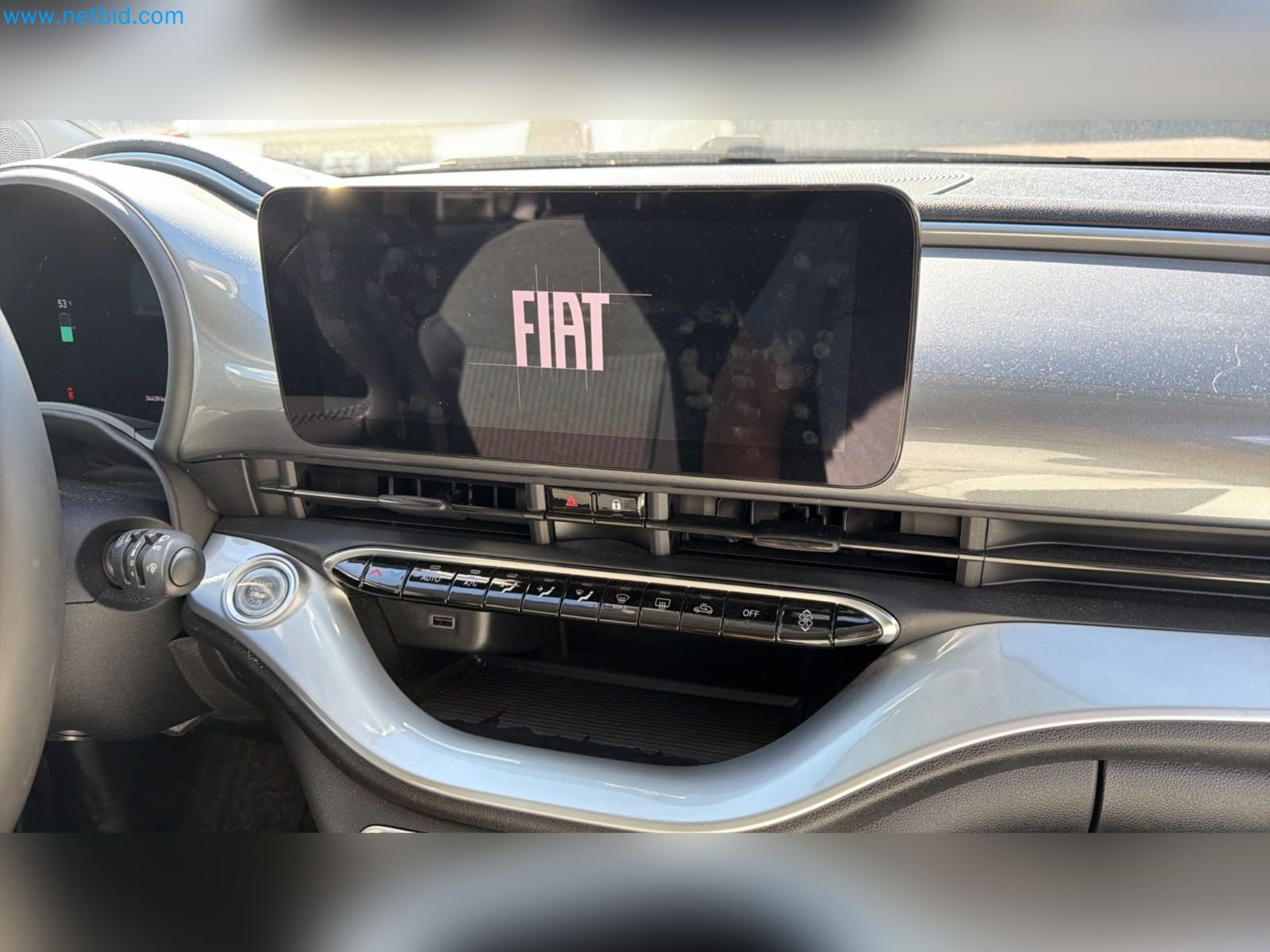 Passenger cars, electric cars, and automotive repair shop equipment at a Fiat dealership-7