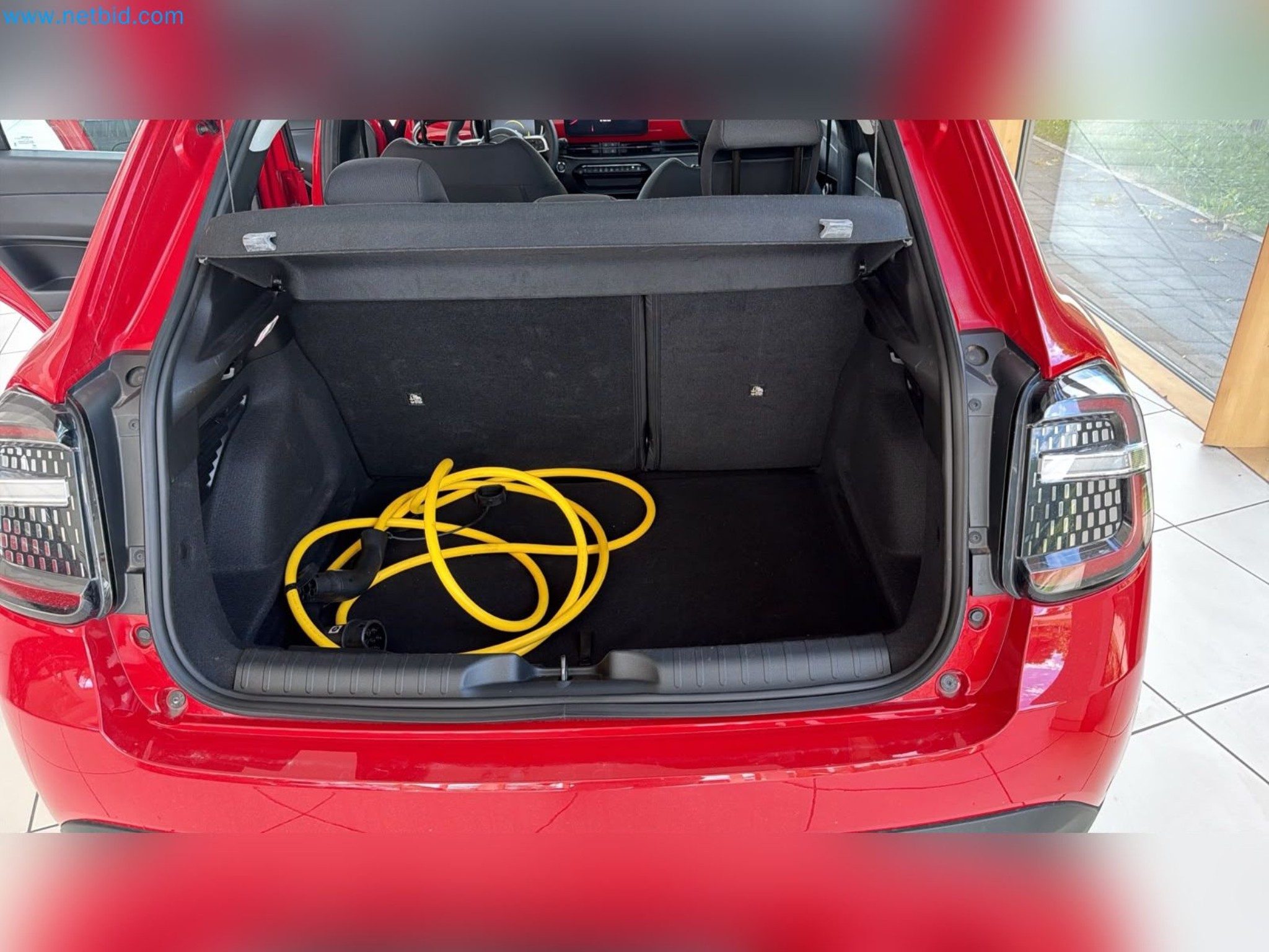 Passenger cars, electric cars, and automotive repair shop equipment at a Fiat dealership-13