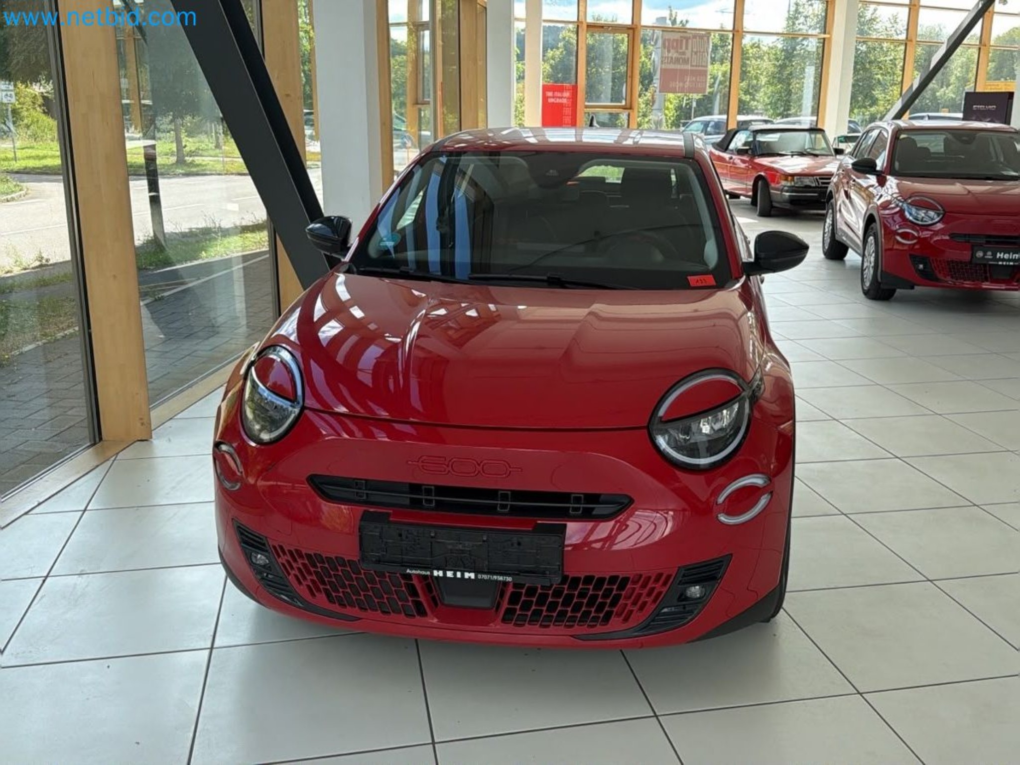 Passenger cars, electric cars, and automotive repair shop equipment at a Fiat dealership-1