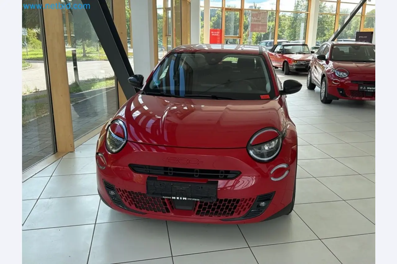 Passenger cars, electric cars, and automotive repair shop equipment at a Fiat dealership-1
