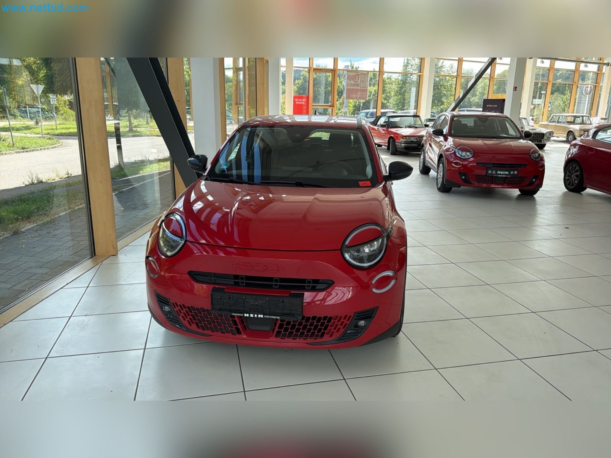 Passenger cars, electric cars, and automotive repair shop equipment at a Fiat dealership-2
