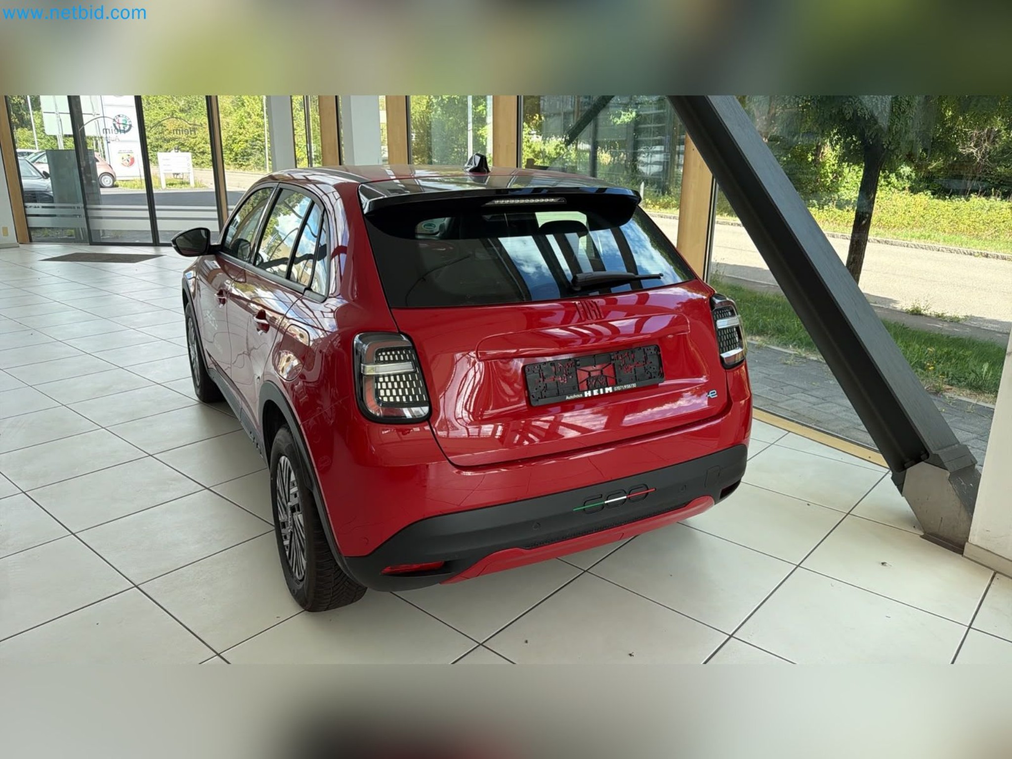 Passenger cars, electric cars, and automotive repair shop equipment at a Fiat dealership-3
