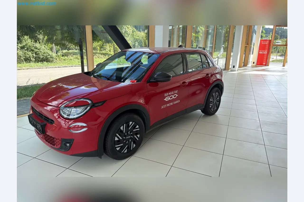 Passenger cars, electric cars, and automotive repair shop equipment at a Fiat dealership-4