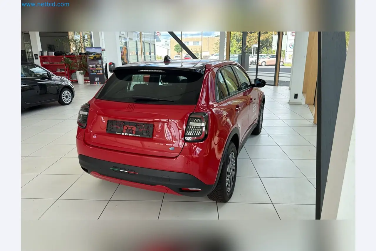 Passenger cars, electric cars, and automotive repair shop equipment at a Fiat dealership-5