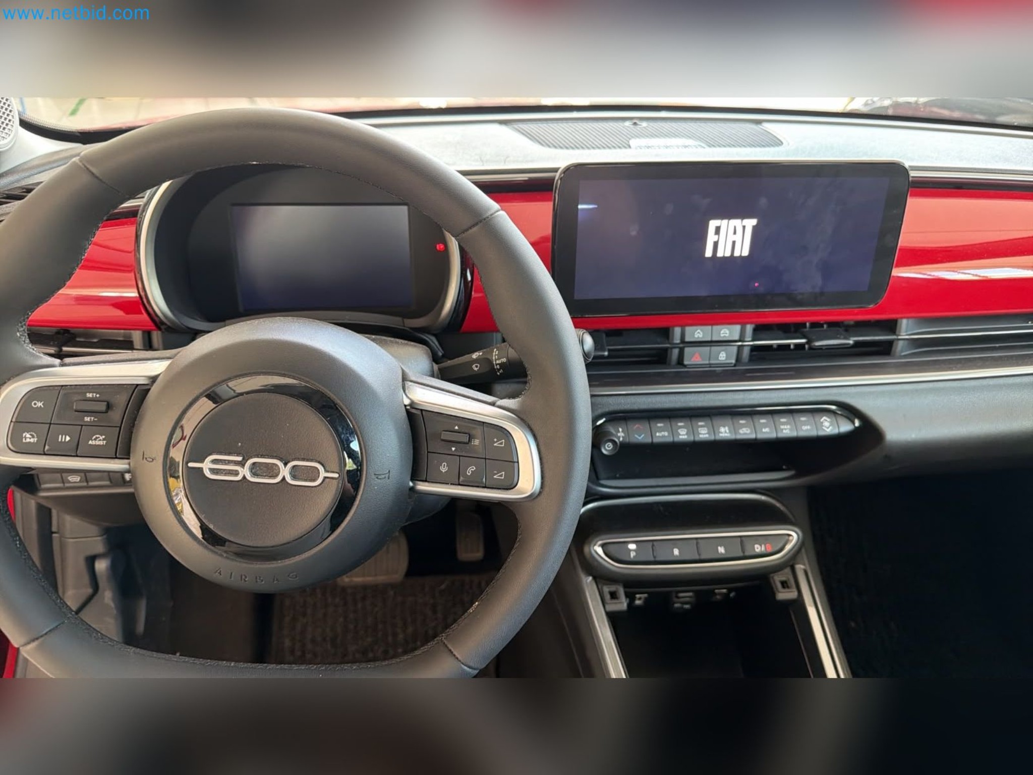 Passenger cars, electric cars, and automotive repair shop equipment at a Fiat dealership-7