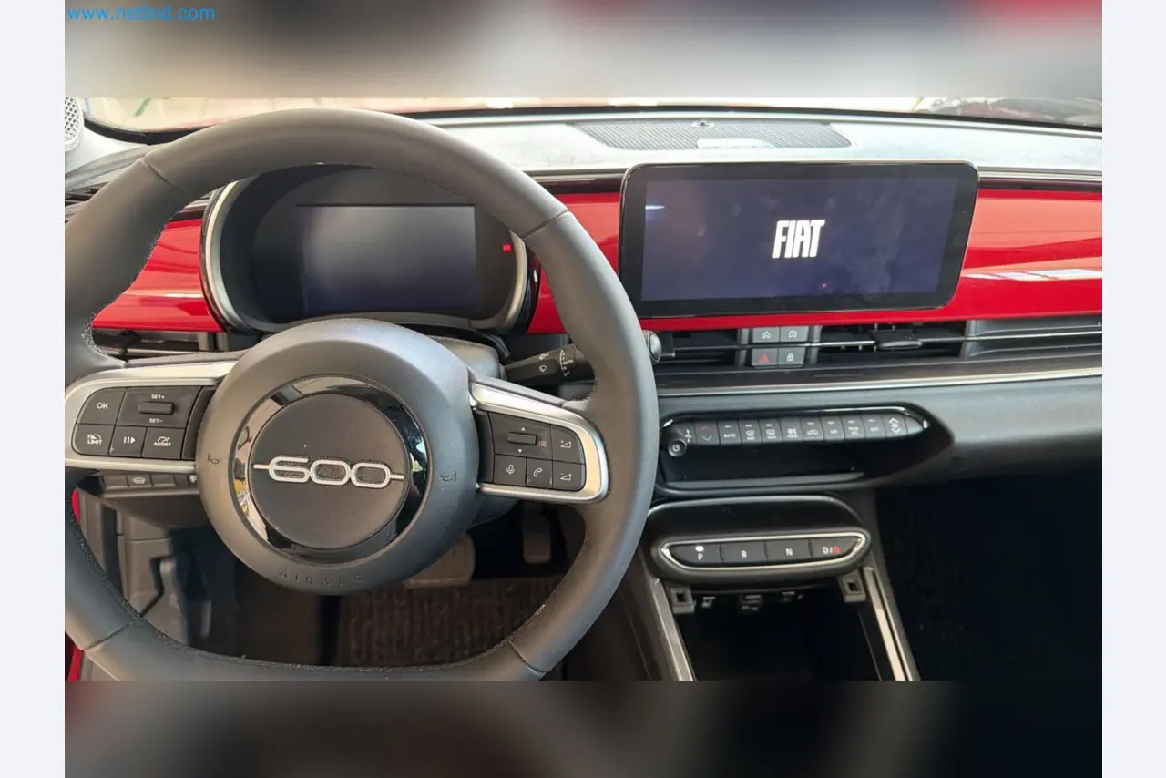 Passenger cars, electric cars, and automotive repair shop equipment at a Fiat dealership-7