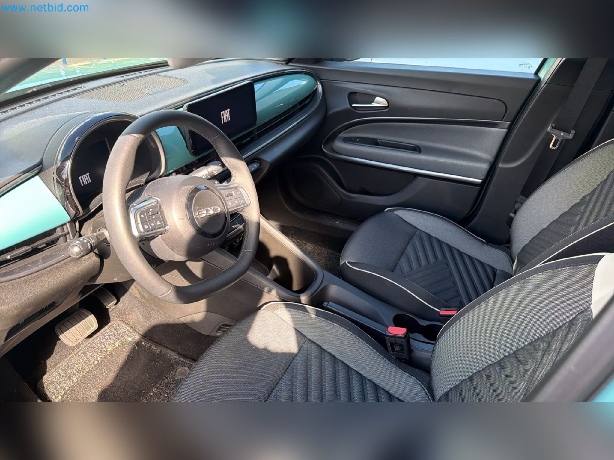 Passenger cars, electric cars, and automotive repair shop equipment at a Fiat dealership-10