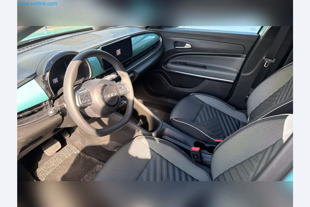Passenger cars, electric cars, and automotive repair shop equipment at a Fiat dealership-10