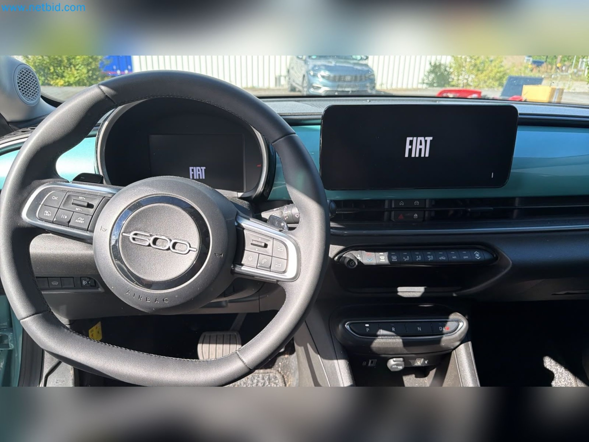 Passenger cars, electric cars, and automotive repair shop equipment at a Fiat dealership-13