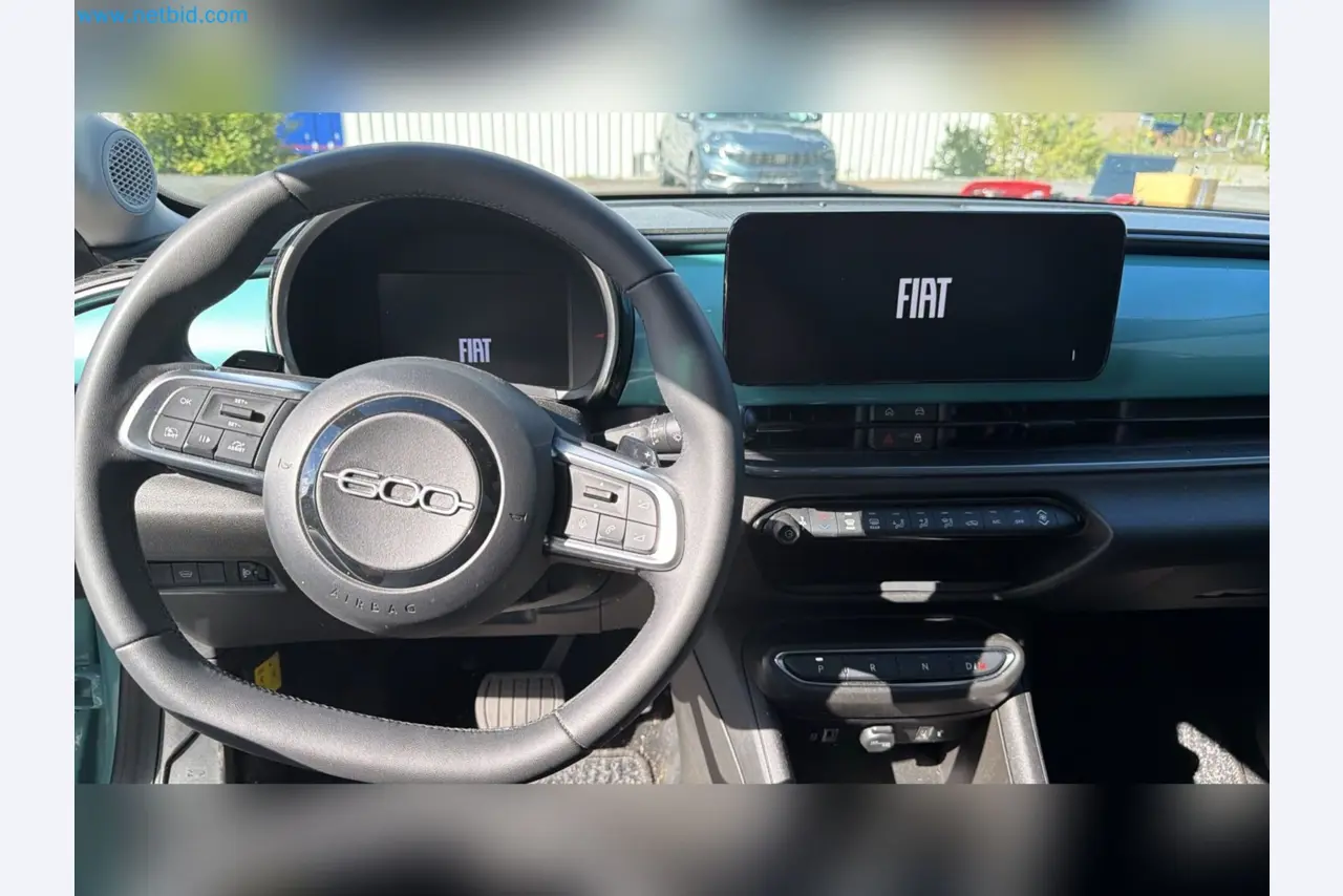 Passenger cars, electric cars, and automotive repair shop equipment at a Fiat dealership-13