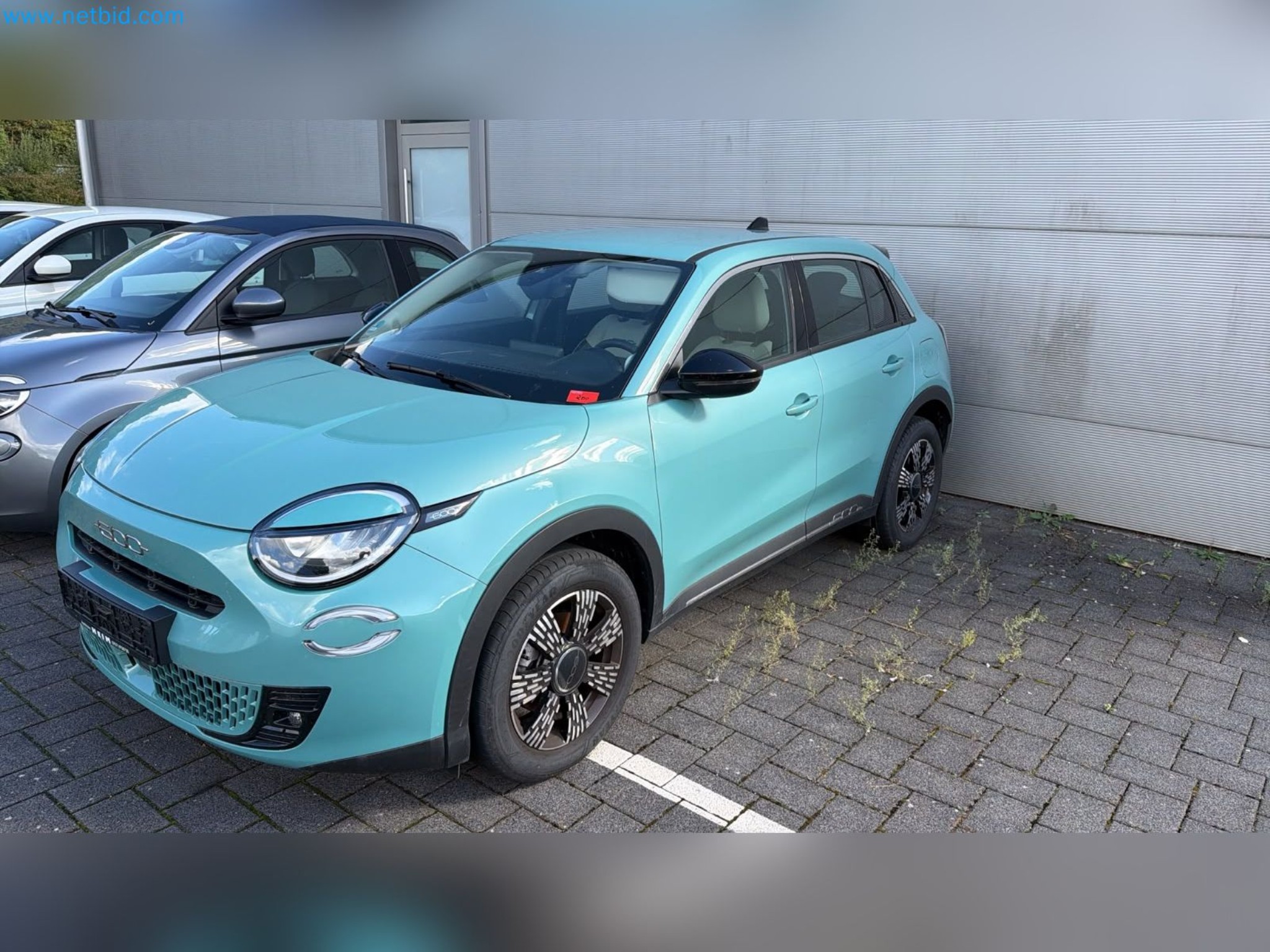 Passenger cars, electric cars, and automotive repair shop equipment at a Fiat dealership-1