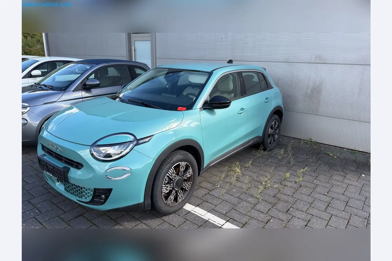 Passenger cars, electric cars, and automotive repair shop equipment at a Fiat dealership-1