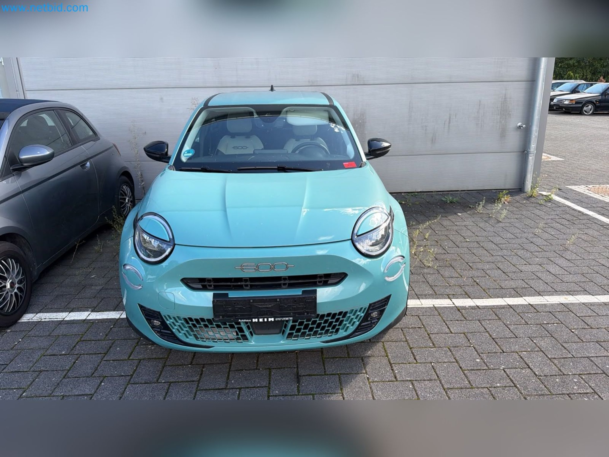 Passenger cars, electric cars, and automotive repair shop equipment at a Fiat dealership-2