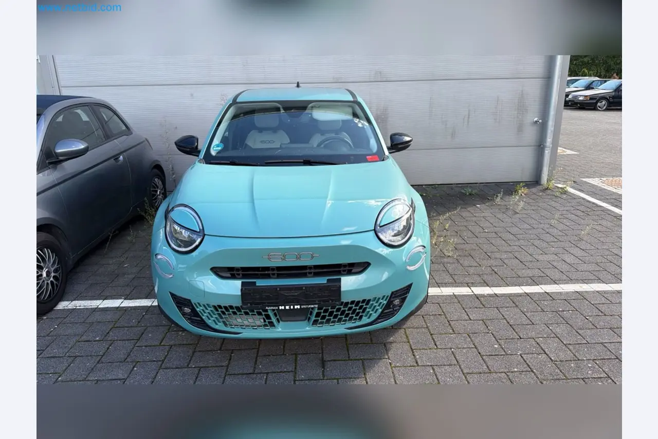 Passenger cars, electric cars, and automotive repair shop equipment at a Fiat dealership-2