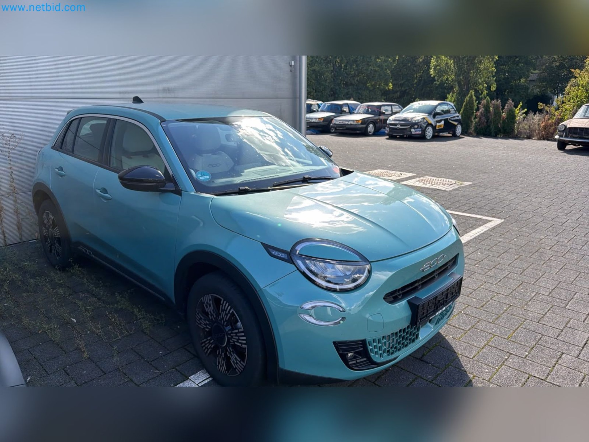 Passenger cars, electric cars, and automotive repair shop equipment at a Fiat dealership-3