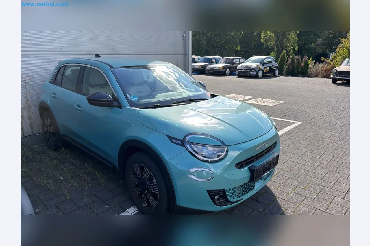 Passenger cars, electric cars, and automotive repair shop equipment at a Fiat dealership-3