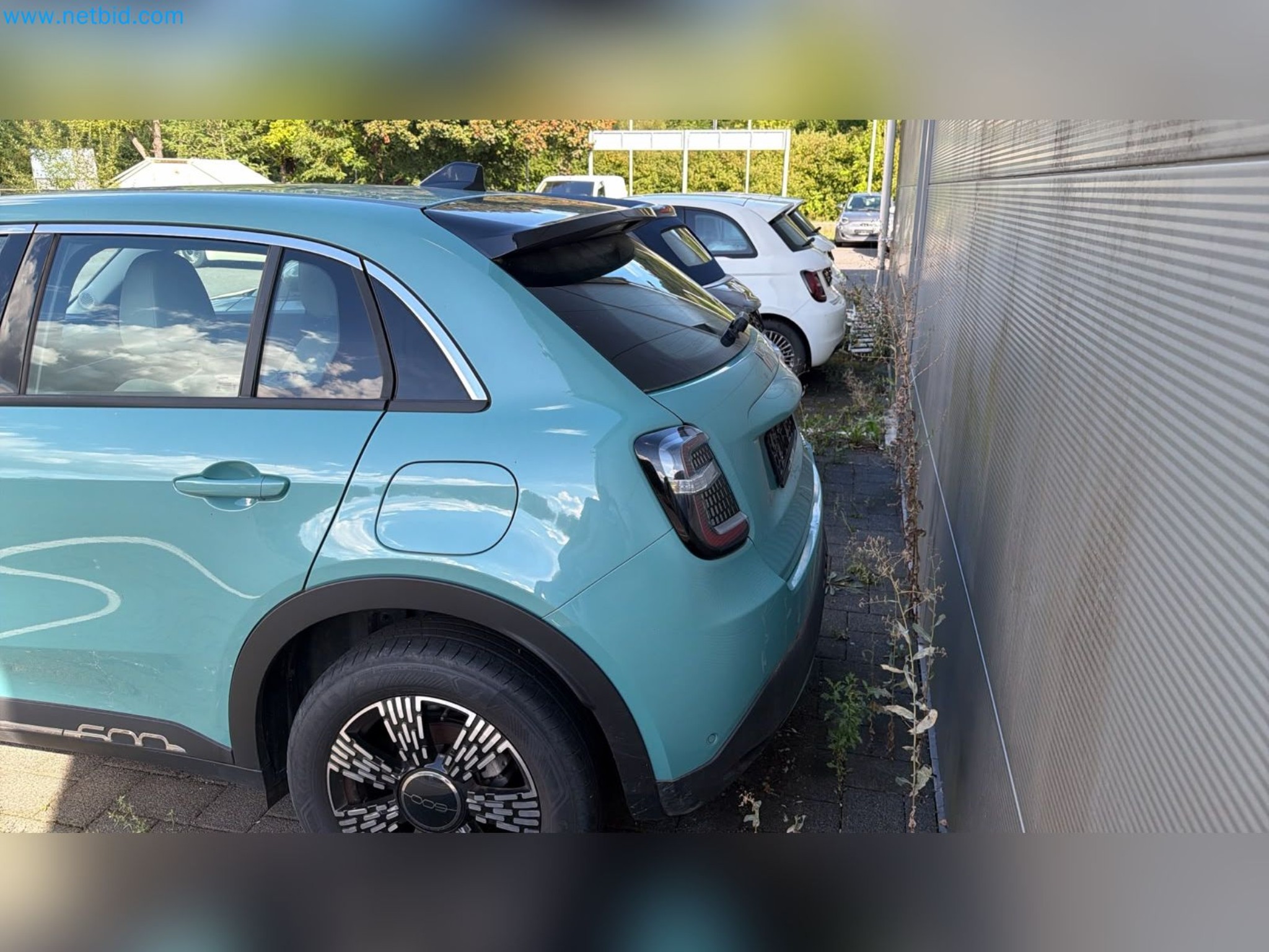 Passenger cars, electric cars, and automotive repair shop equipment at a Fiat dealership-4