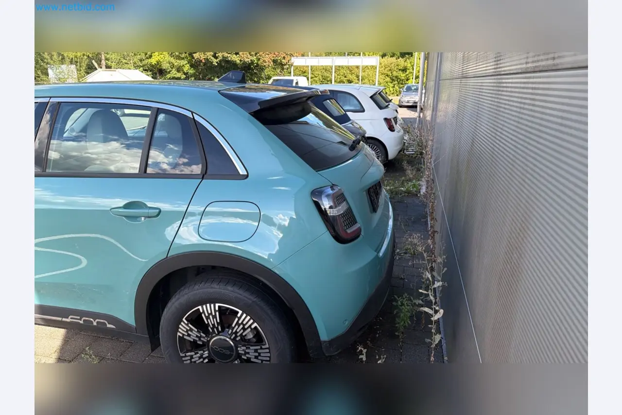 Passenger cars, electric cars, and automotive repair shop equipment at a Fiat dealership-4