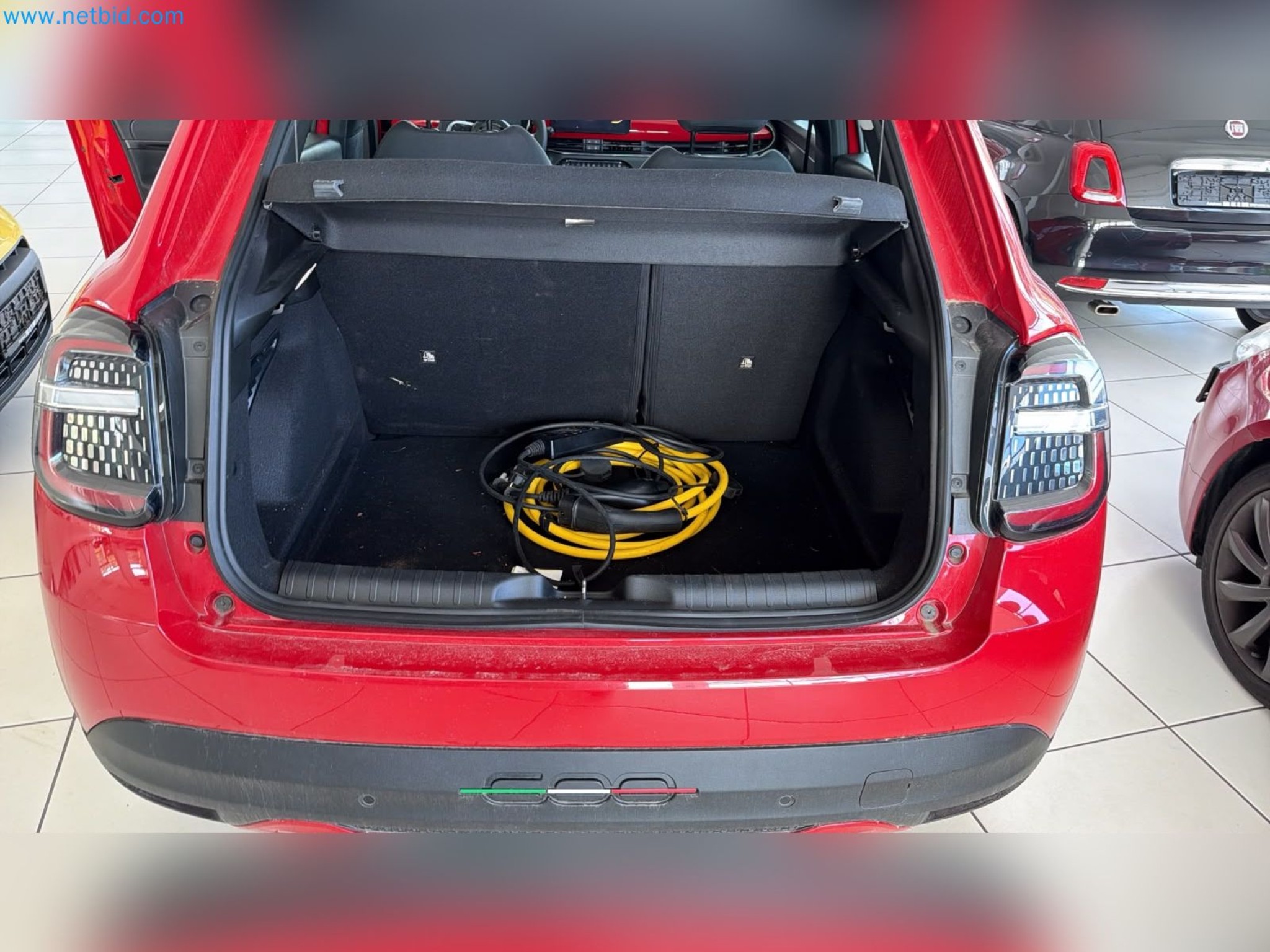 Passenger cars, electric cars, and automotive repair shop equipment at a Fiat dealership-10