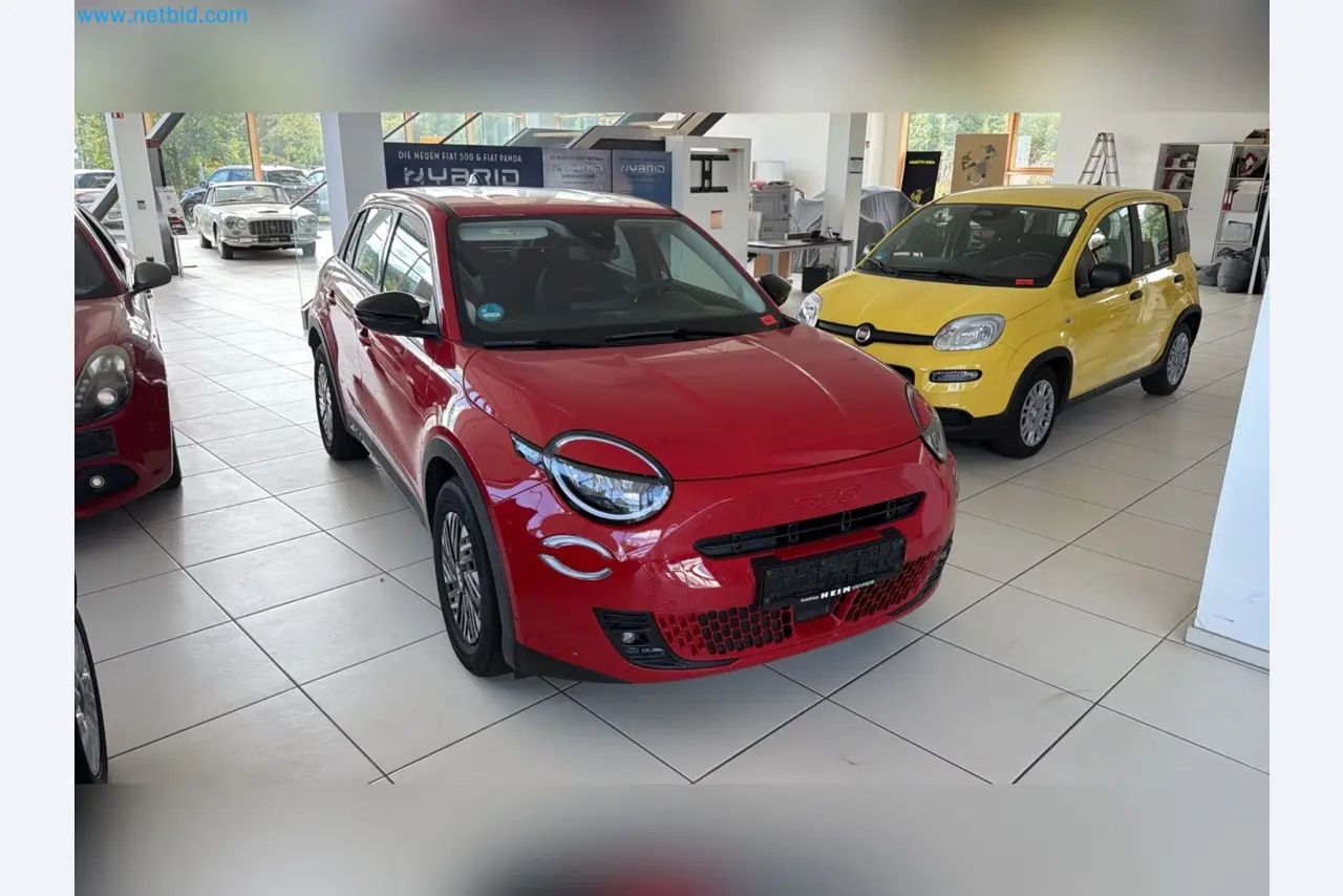 Passenger cars, electric cars, and automotive repair shop equipment at a Fiat dealership-1
