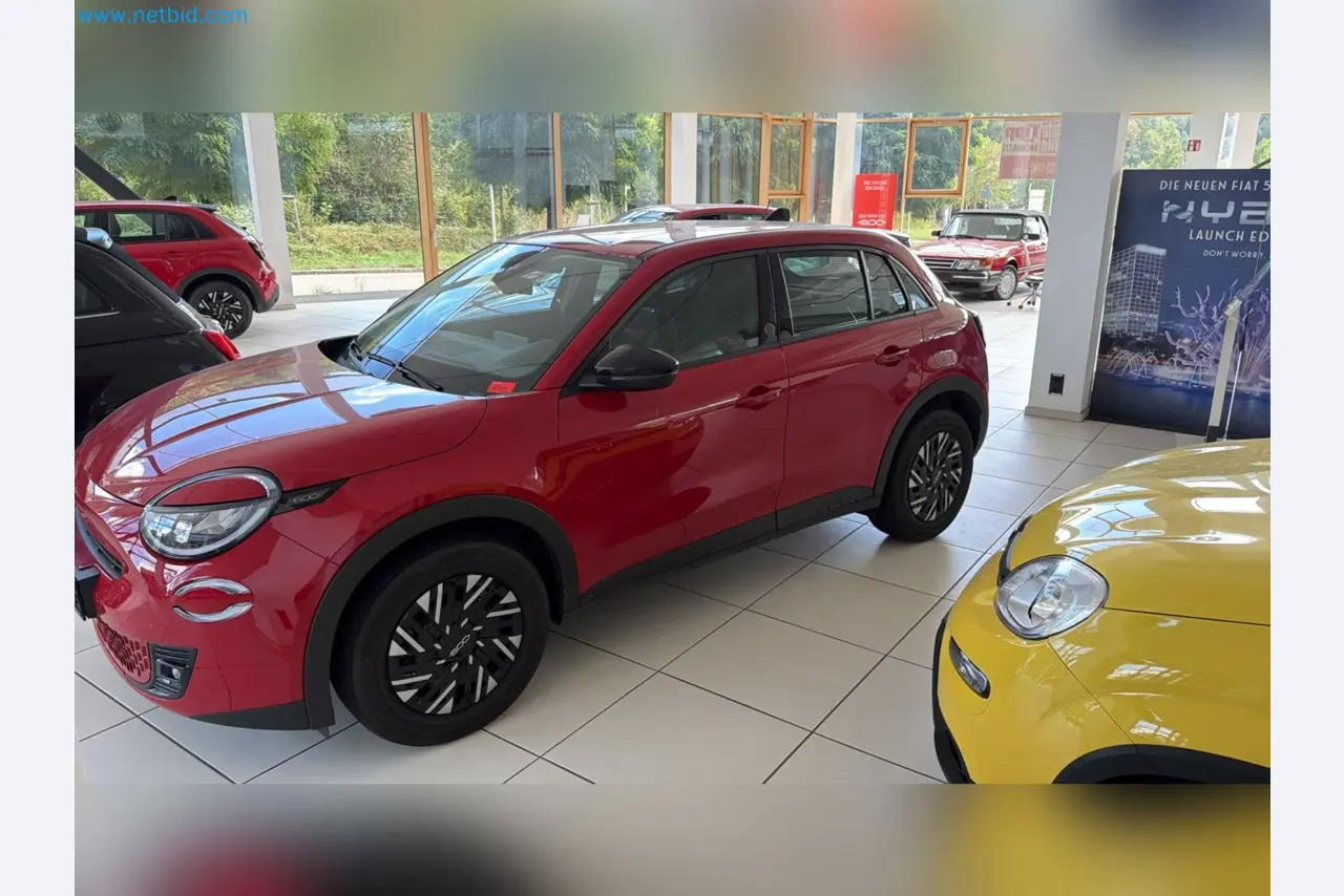 Passenger cars, electric cars, and automotive repair shop equipment at a Fiat dealership-2