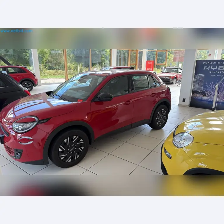 Passenger cars, electric cars, and automotive repair shop equipment at a Fiat dealership-2