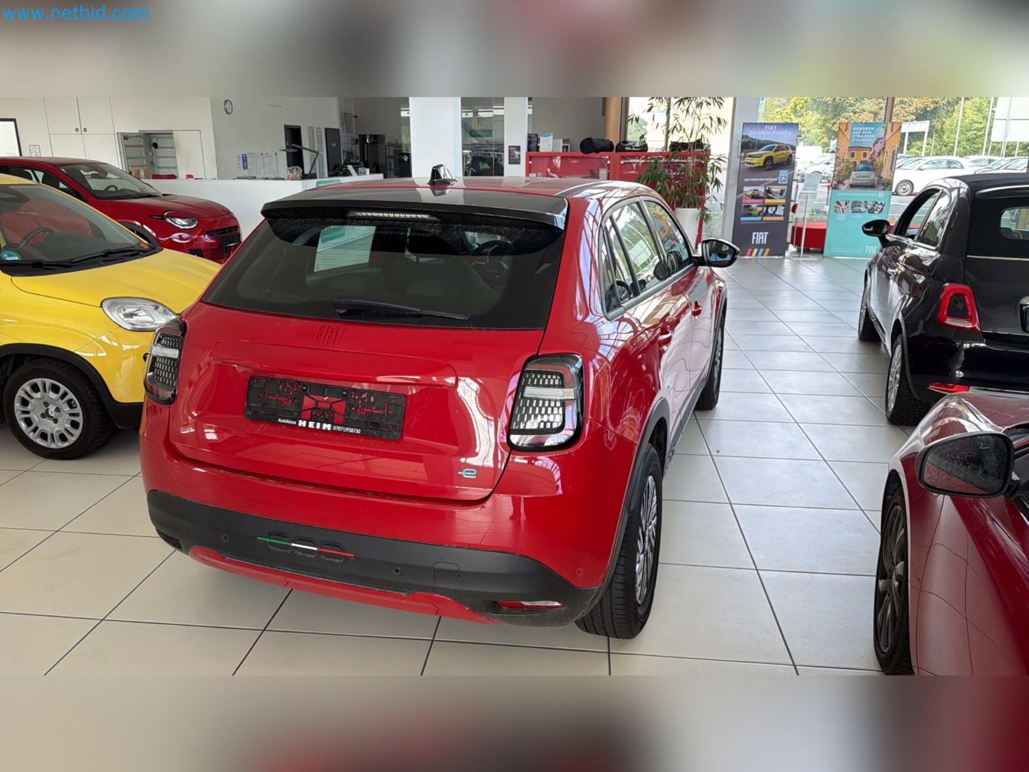 Passenger cars, electric cars, and automotive repair shop equipment at a Fiat dealership-9