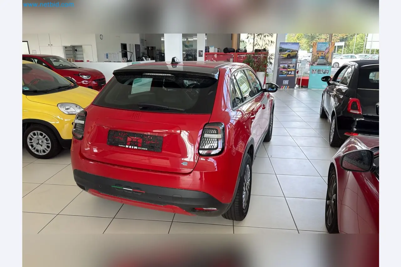 Passenger cars, electric cars, and automotive repair shop equipment at a Fiat dealership-9