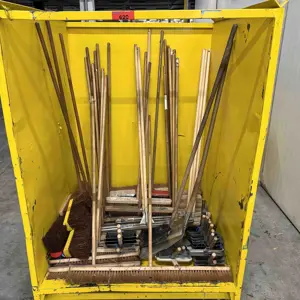 Container with various cleaning tools and accessories.