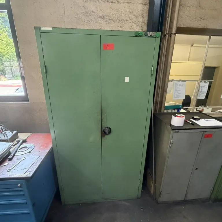 Metal cabinet with clamping device